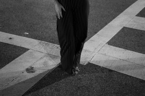 Free Black and white street angle with a person in striped pants and sandals. Stock Photo