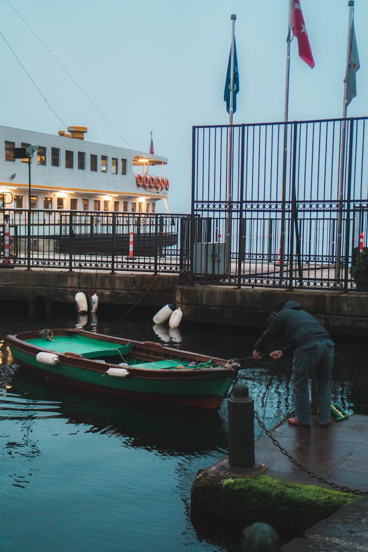 A Man Pulling Boat From The Dock