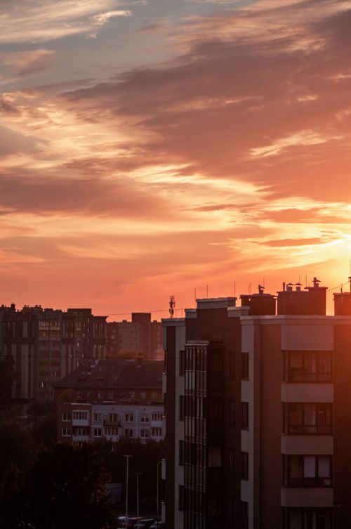 Free A breathtaking view of Kaliningrad's modern skyline at sunset, featuring high-rise buildings silhouette against a vivid sky. Stock Photo