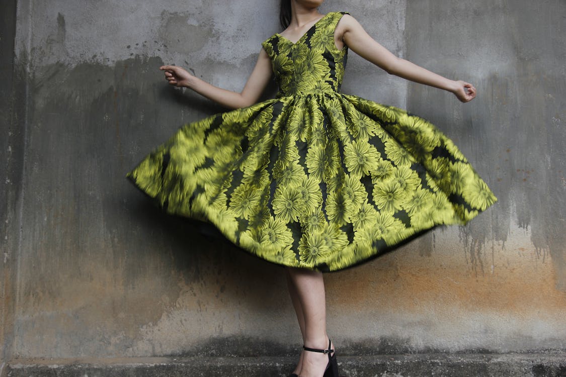 Photo of a Woman Wearing Green Dress