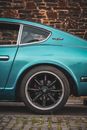 Teal Car on Brown Soil