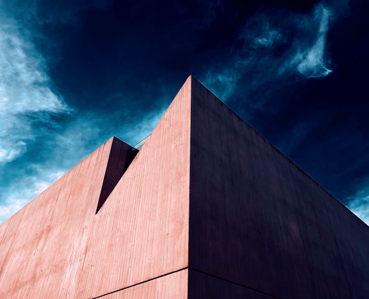 Geometric Modern Building On Dark Storm Sky