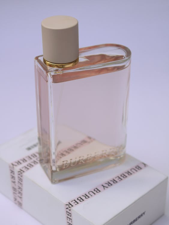 Free Clear Glass Perfume Bottle on White Paper  Box Stock Photo