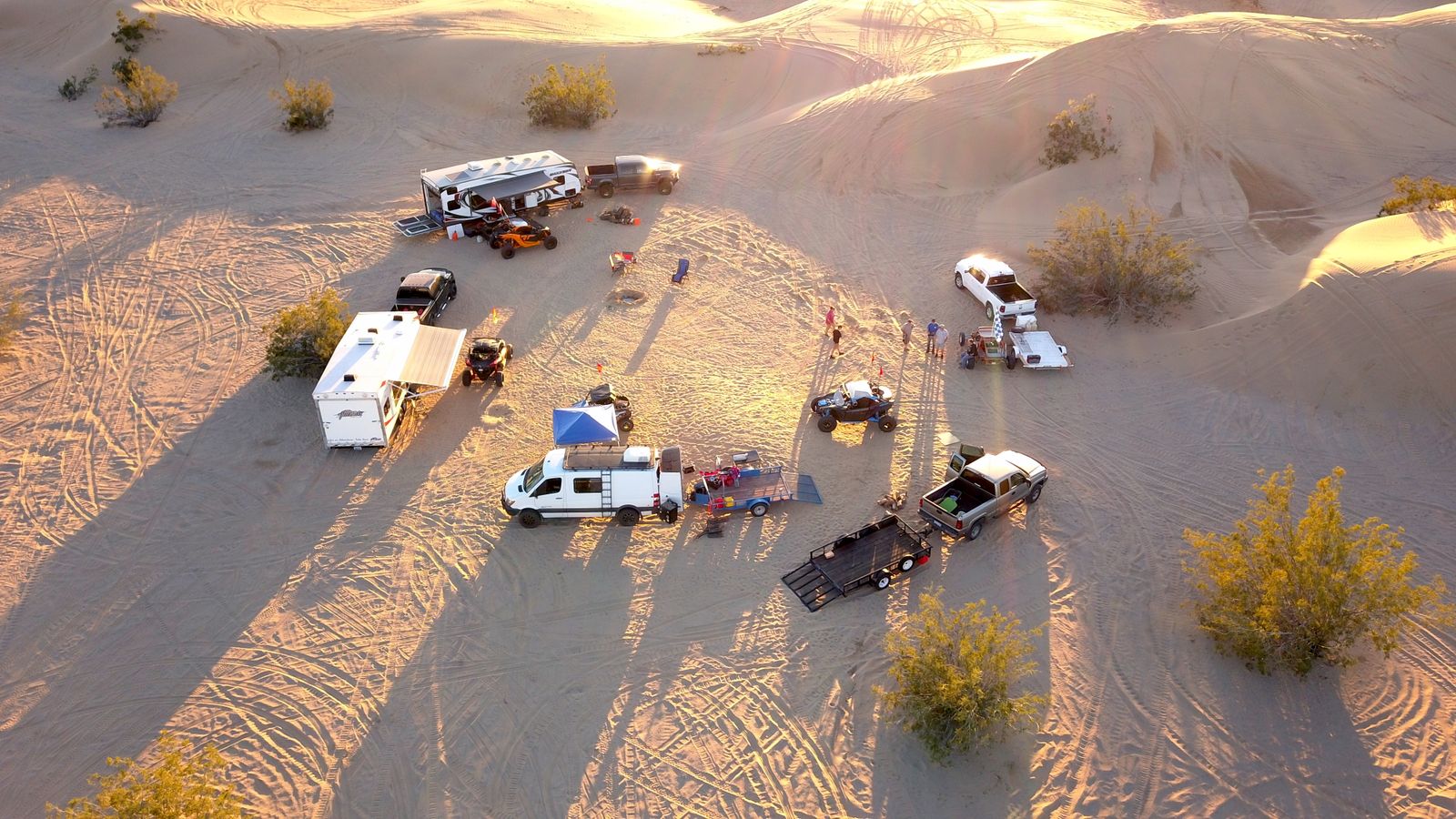 Aerial view of a high-desert campsite with trailers at sunrise — photo by Daniel Boord on Pexels