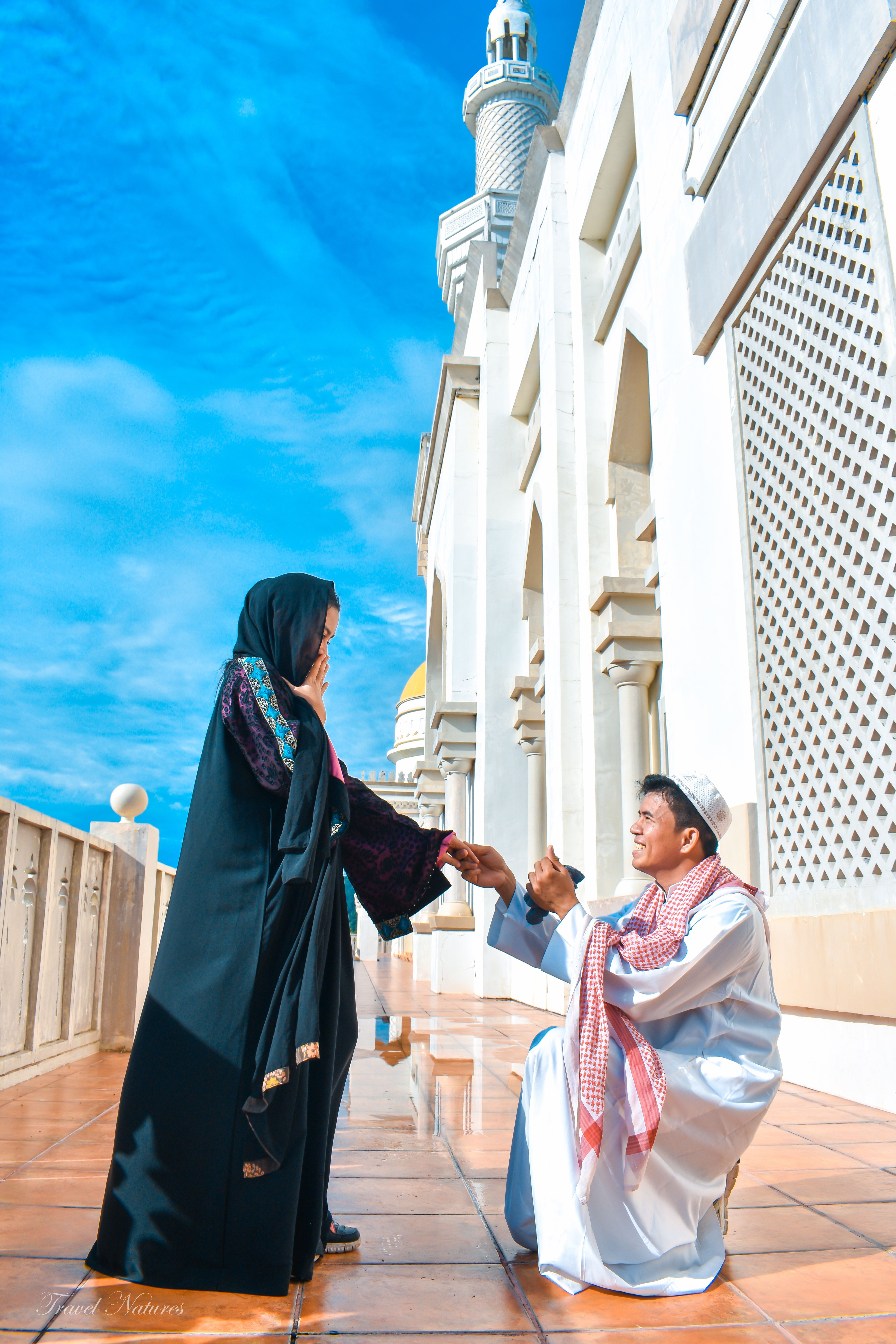 A couple's romantic engagement proposal capturing love against the stunning architecture of Cotabato City's Grand Mosque.