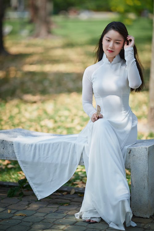 A Woman in White Dress Sitting on the Bench · Free Stock Photo