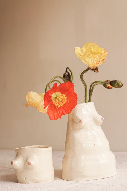 Yellow and Red Flower in White Ceramic Vase