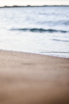 Soft waves meeting the sandy shore in Adicora, Venezuela. Perfect for tranquil beach scenes.