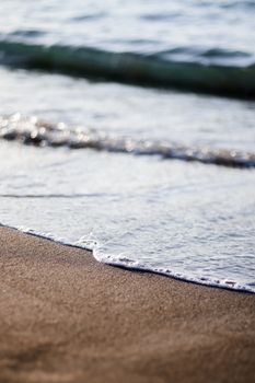 Tranquil beach scene with soft waves and sandy shore in Adicora, Venezuela.