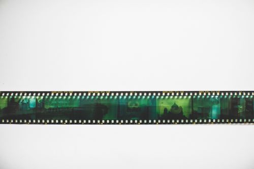 Free Close-up of a retro 35mm camera film negative strip against a white background. Stock Photo