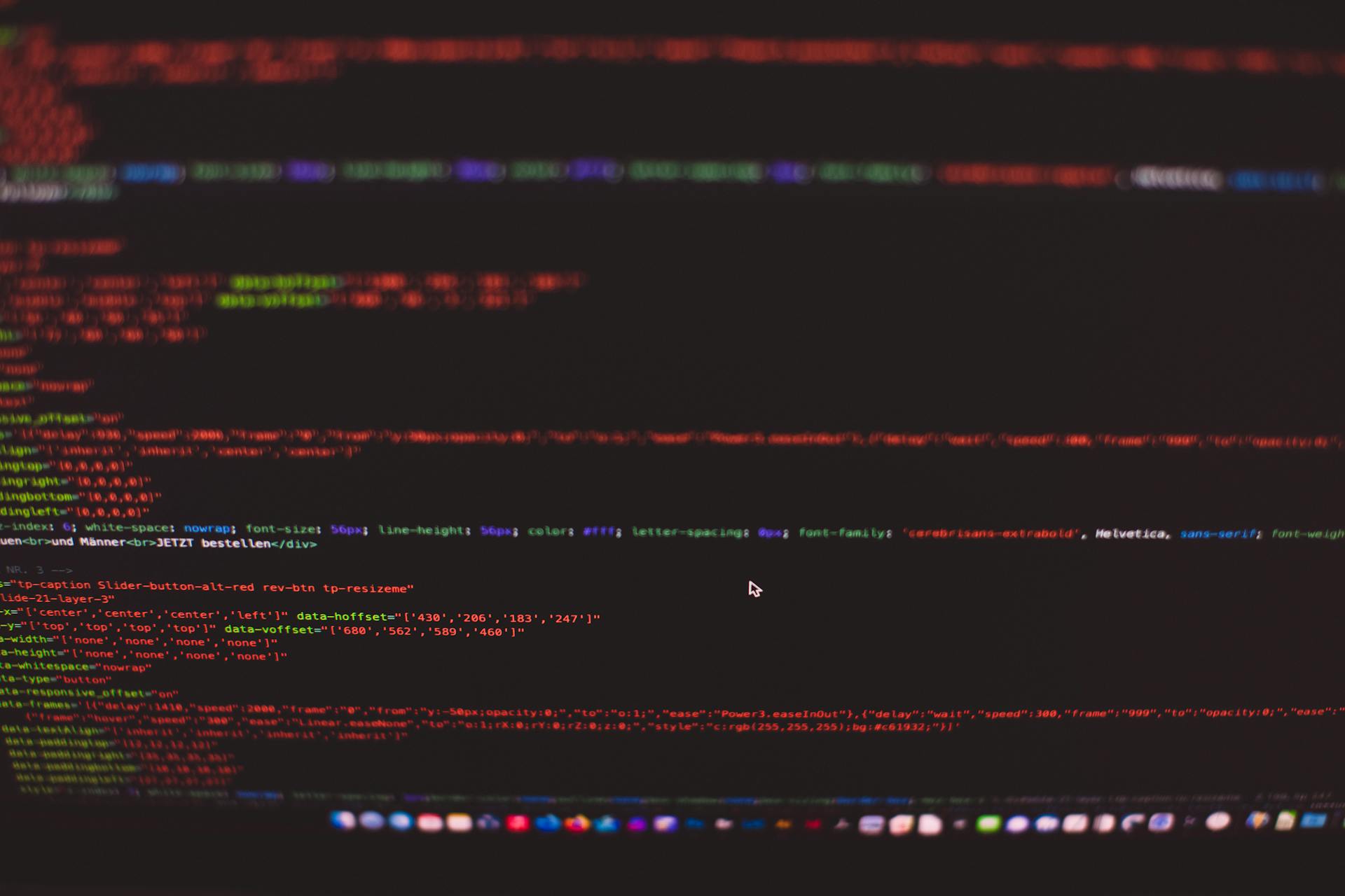 Close-up view of colorful CSS and HTML code displayed on a dark computer screen.