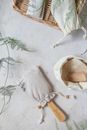 White and Brown Wooden Round Basket on White Textile