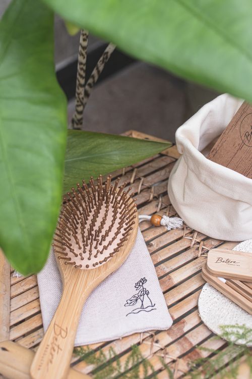 Free Eco-friendly wooden hairbrush with pouch on bamboo mat, promoting zero waste lifestyle. Stock Photo