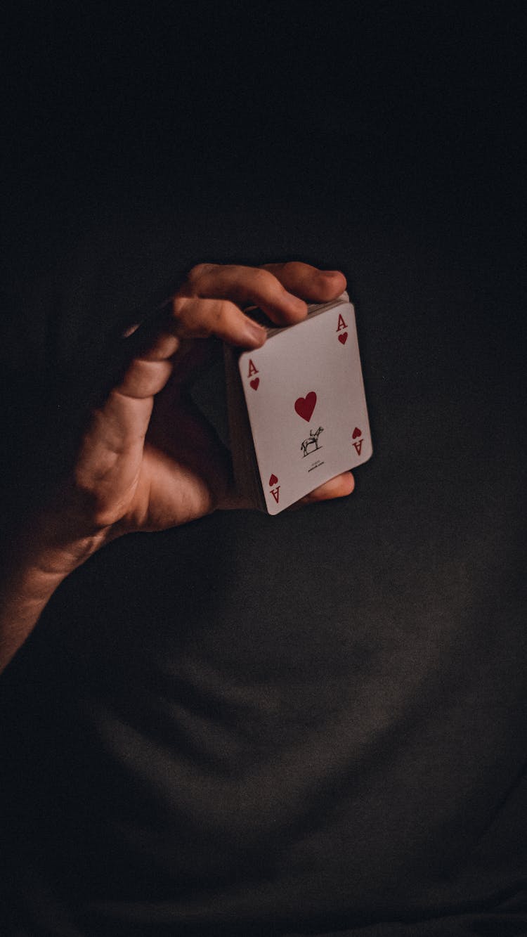 Person Holding A Deck Of Cards