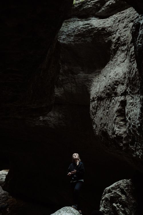Girl Looking Over Rocks A Woman Standing on a Rock Looking Up · Free Stock Photo