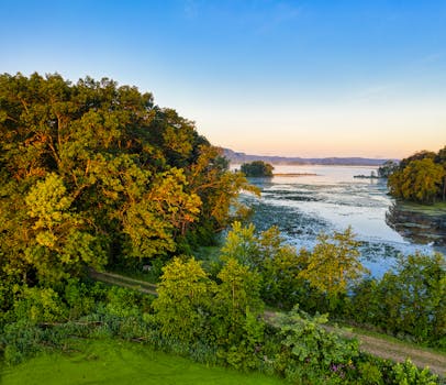 Aerial shot of the peaceful Trempealeau River and its lush surroundings at sunset in Wisconsin.