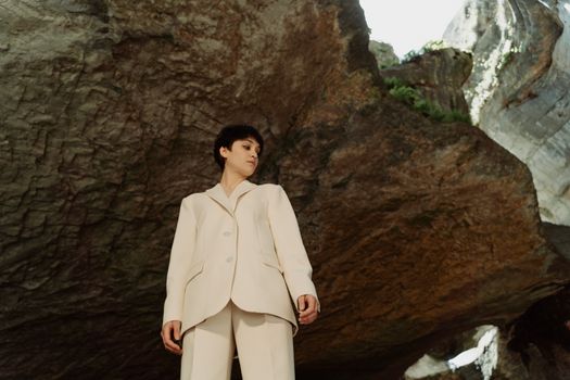 Low-Angle Shot of a Woman Wearing a Blazer in a Cave
