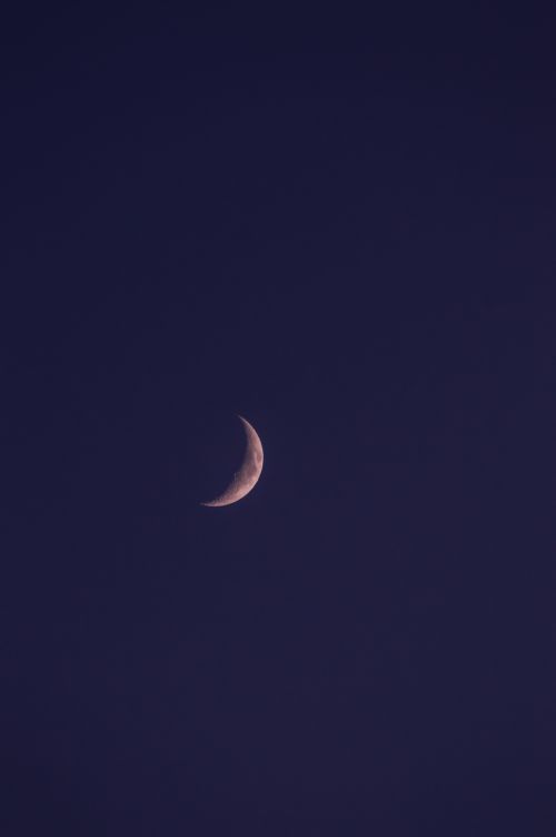 Free Serene crescent moon against a deep, dark night sky. Stock Photo