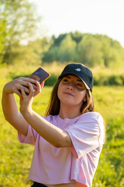 Free A Woman Taking Selfie Using a Smartphone Stock Photo