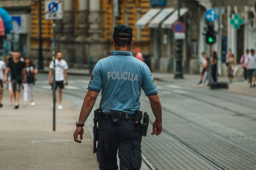 Police officer walking down a city street