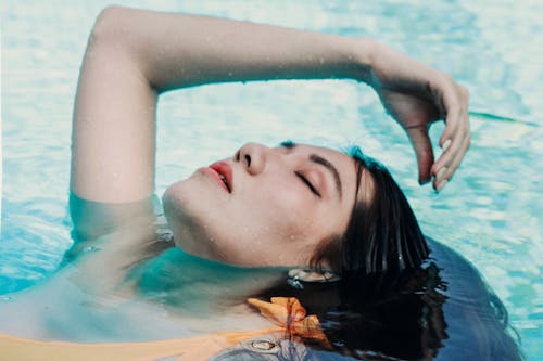 Woman Floating on the Swimming Pool