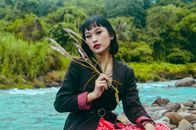 A Woman in Black Blazer Sitting Near the River