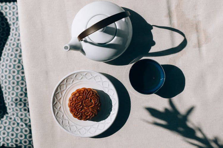 Mooncake On Saucer And A Cup Of Tea