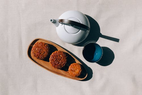 Blue Ceramic Teapot Beside White Ceramic Teapot