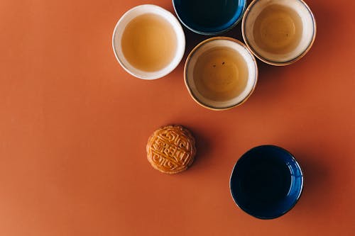 Blue Ceramic Mug Beside Brown Round Cookie