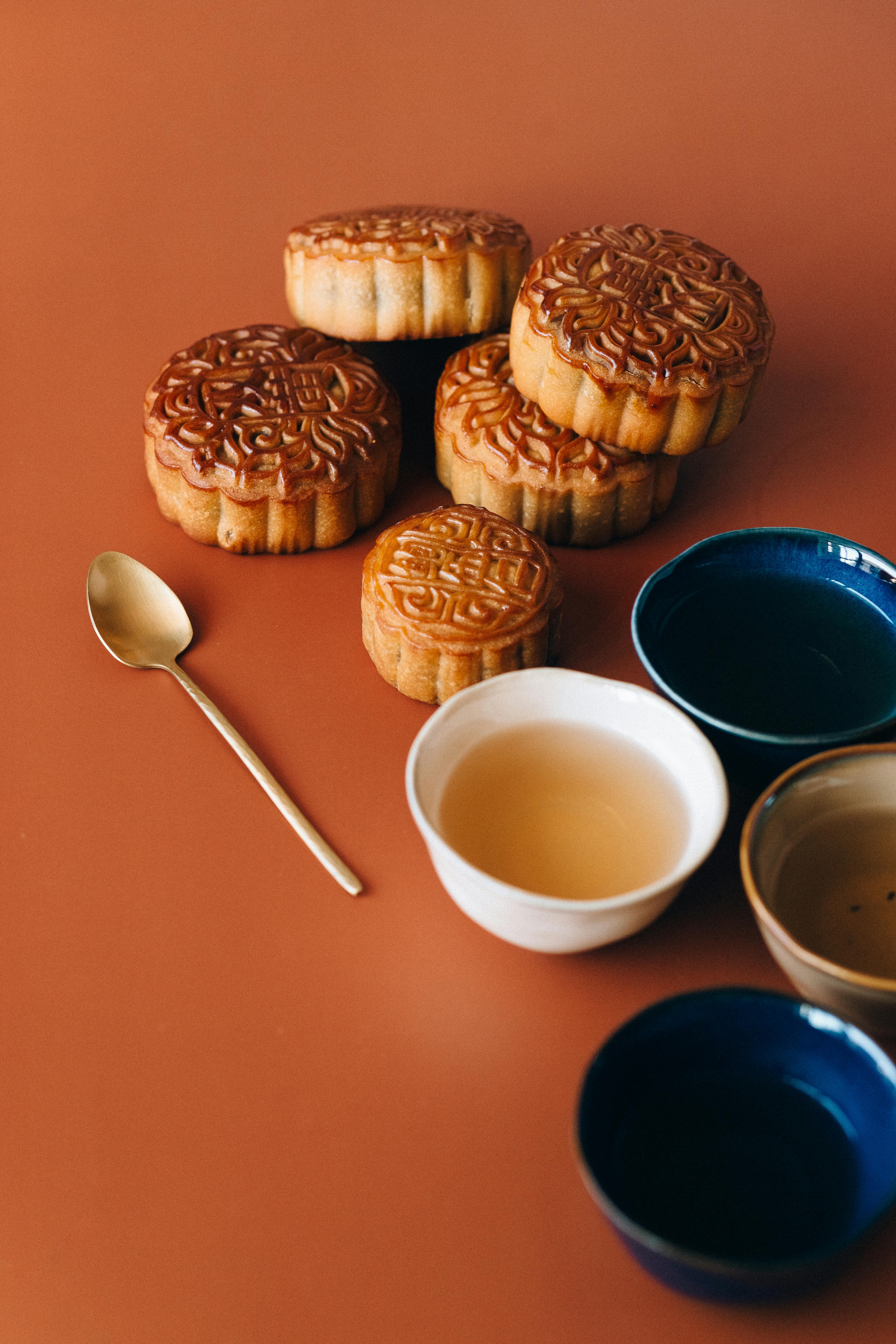 desserts on orange surface beside a spoon