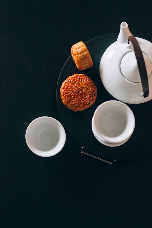 Mooncake Beside White Ceramic Teapot