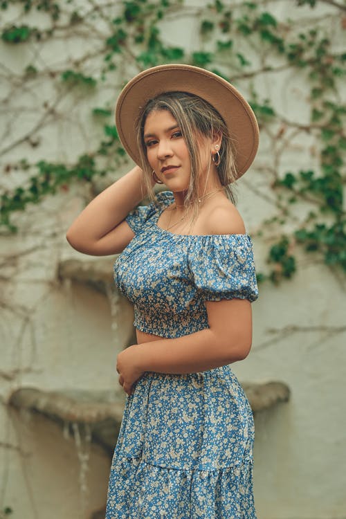 Beautiful Woman Wearing a Hat and a Floral Dress