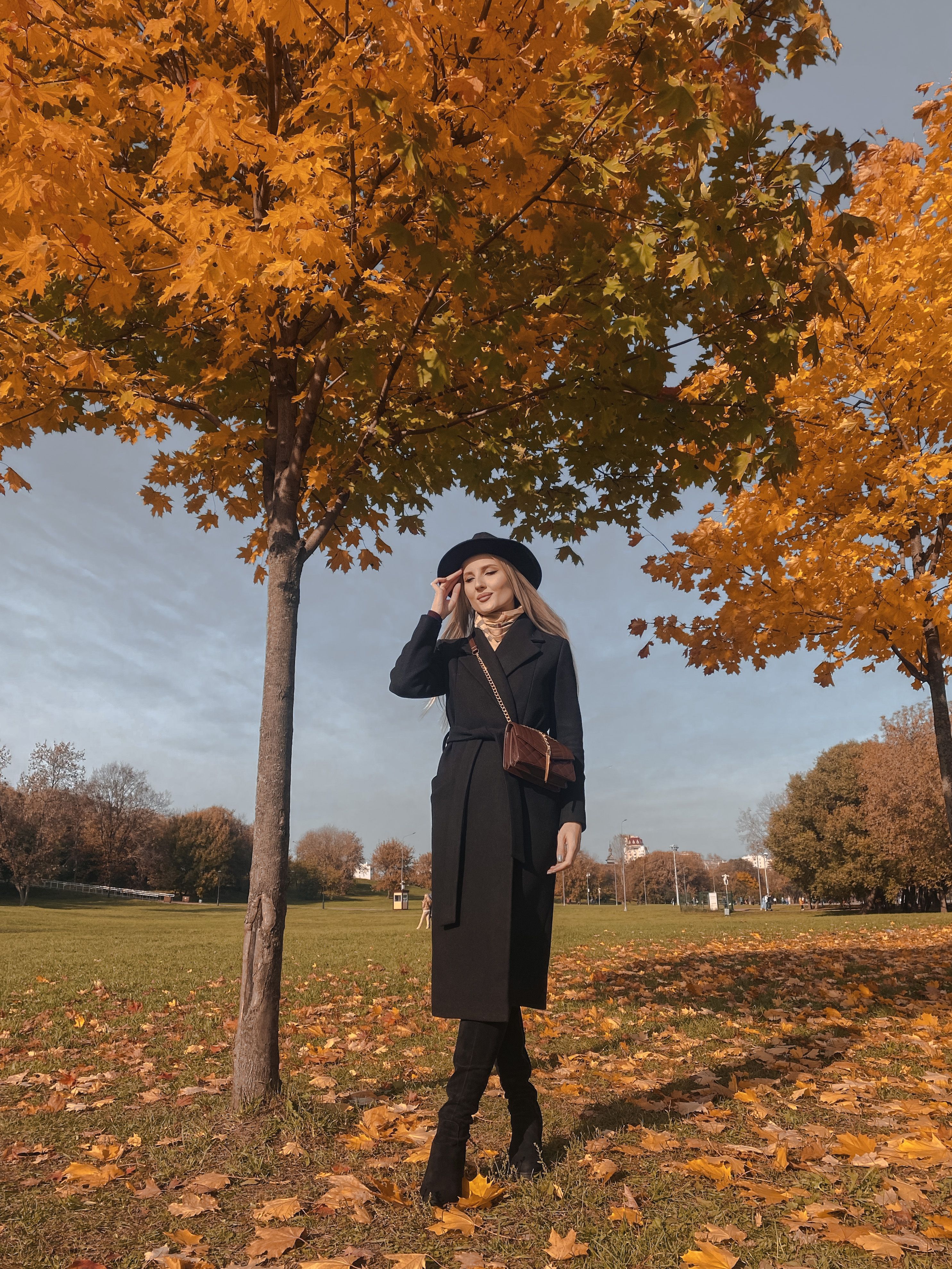 Woman in Black Coat Standing near a Tree · Free Stock Photo