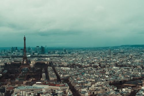 Free A panoramic aerial view of Paris cityscape featuring the iconic Eiffel Tower at sunset. Stock Photo
