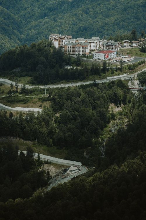 Free A scenic aerial view of Красная Поляна village nestled in lush green mountains. Stock Photo