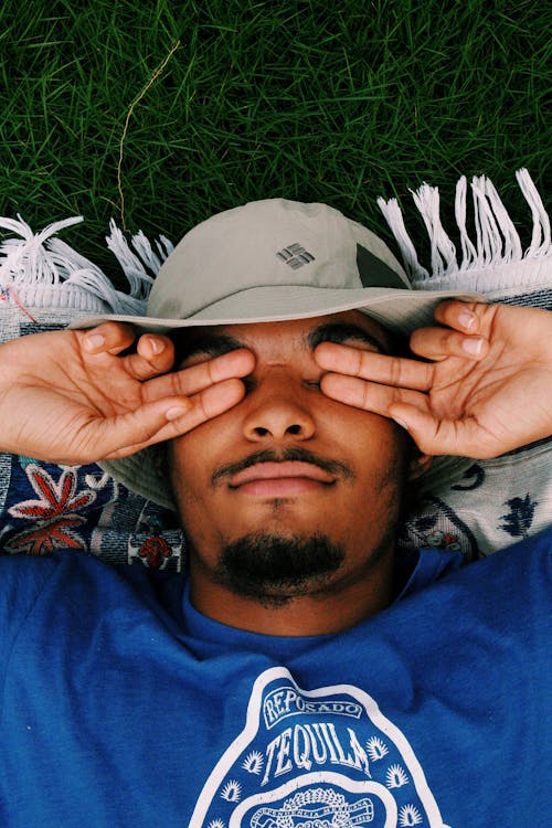 Man Covering His Eyes in Close Up Photography