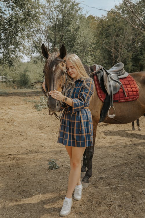 Blond Woman Leaning on a Horse