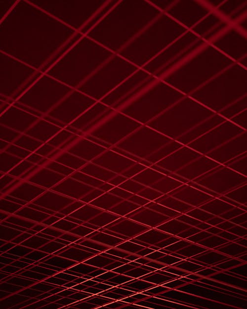 Free Black Background with Red Intercrossing Lines Stock Photo