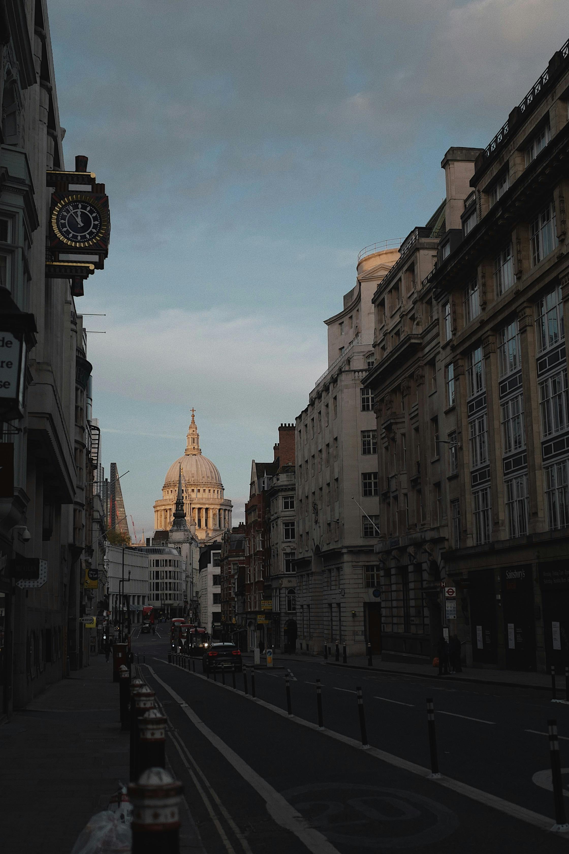 Street view of London featuring St. Paul's Cathedral at dusk, capturing the city's architecture.