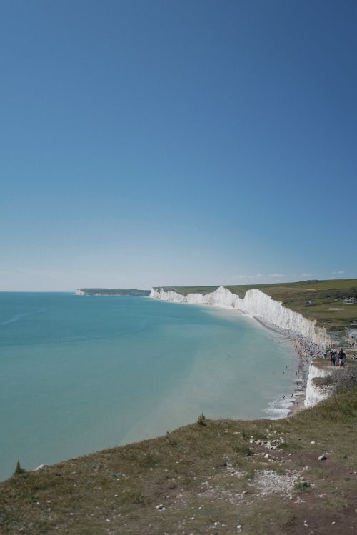 Free Explore the stunning white cliffs and blue waters along the Seven Sisters coastline. Stock Photo