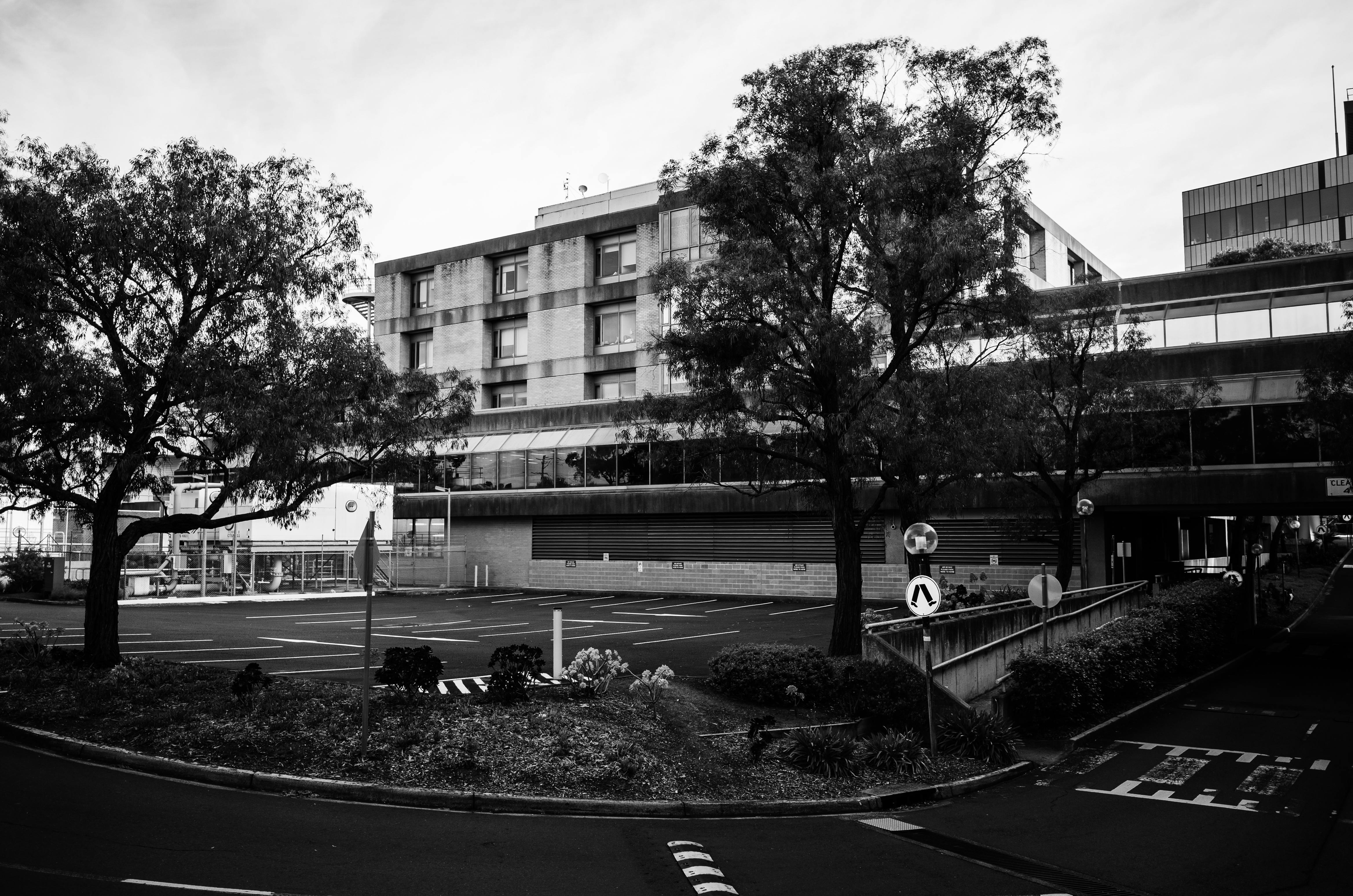 Empty Car Park Near a Building and the Road · Free Stock Photo