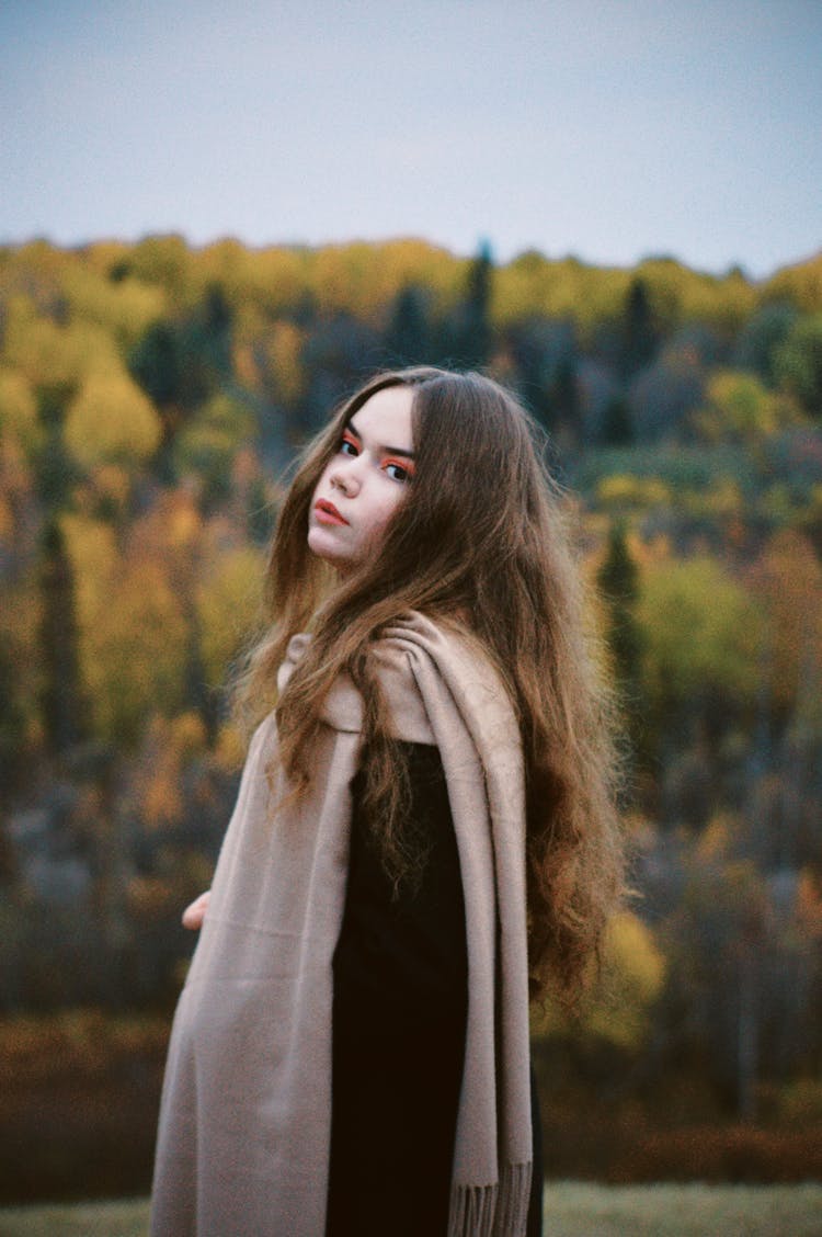 A Young Girl Wearing A Beige Scarf