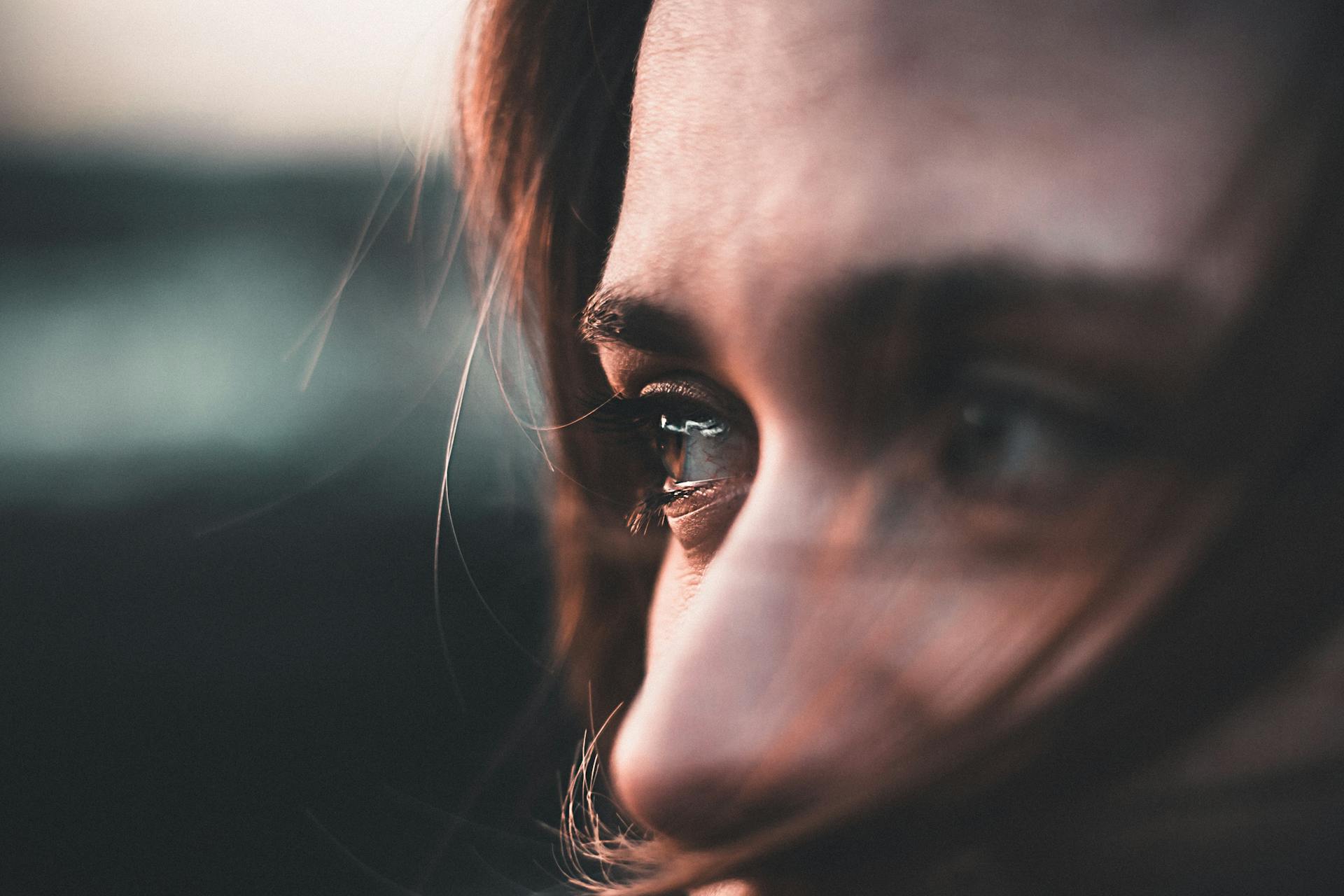 A stunning close-up portrait capturing deep emotions in a warm sunset light.