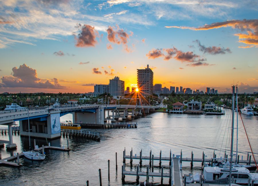 Picturesque sunrise over Las Olas Bridge in Fort Lauderdale, capturing the marina and skyline.