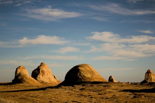 Free Explore a remote desert with mystical sandstone formations under a blue sky. Stock Photo