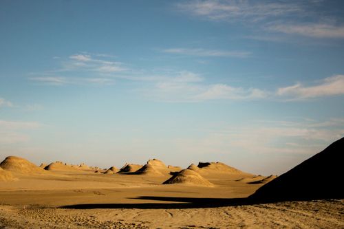 Free Vast desert with unique sand dunes under a bright blue sky. Stock Photo