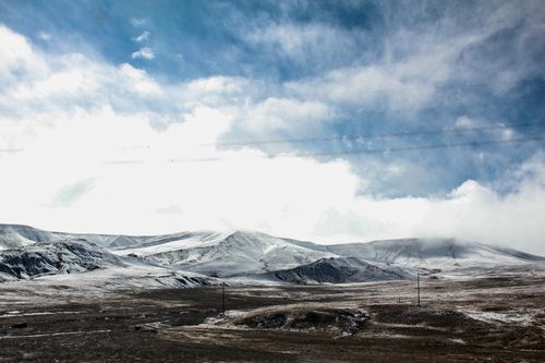 Free Stunning snow-covered mountains under a bright blue sky showcase winter's pristine beauty. Stock Photo