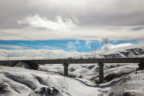 Gray Concrete Bridge Under White Clouds