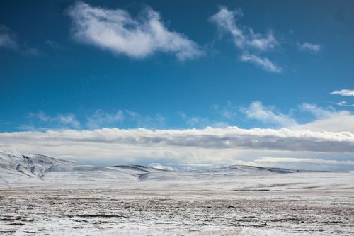 Free Expansive snow-covered mountains under a clear blue sky. Stock Photo