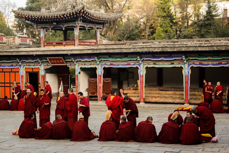 Monks Wearing Red Robe In A Monastery 